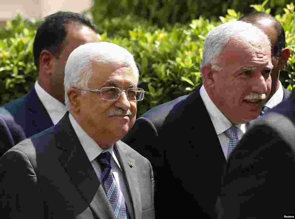 Palestinian President Mahmoud Abbas and his foreign minister Riyad al-Maliki, right arrive for an Arab League Foreign Ministers emergency meeting at the league's headquarters in Cairo, Sept. 7, 2014.
