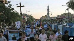 Muslims and Christians chant anti-terrorist slogans during a funeral of slain Christians in Baghdad, Iraq, 02 Nov 2010.