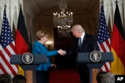 President Donald Trump and German Chancellor Angela Merkel shake hands at a joint news conference in the East Room of the White House in Washington, March 17, 2017.
