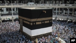 FILE - Muslim pilgrims circle the Kaaba, the cubic building built by Prophet Abraham in the holy city of Mecca, Saudi Arabia. 