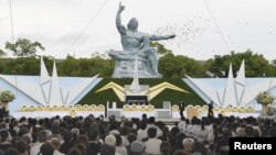 Doves fly over the Peace Statue in Nagasaki's Peace Park during a ceremony commemorating the 72nd anniversary of the bombing of the city, in Nagasaki, Japan, in this photo taken by Kyodo August 9, 2017. Mandatory credit Kyodo/via REUTERS