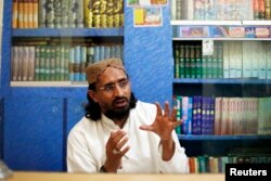 FILE - Aurangzeb Farooqi, leader of Ahl-e-Sunnat Wal Jamaat (ASWJ) gestures during an interview with Reuters at his office in Karachi, Feb. 13, 2013.