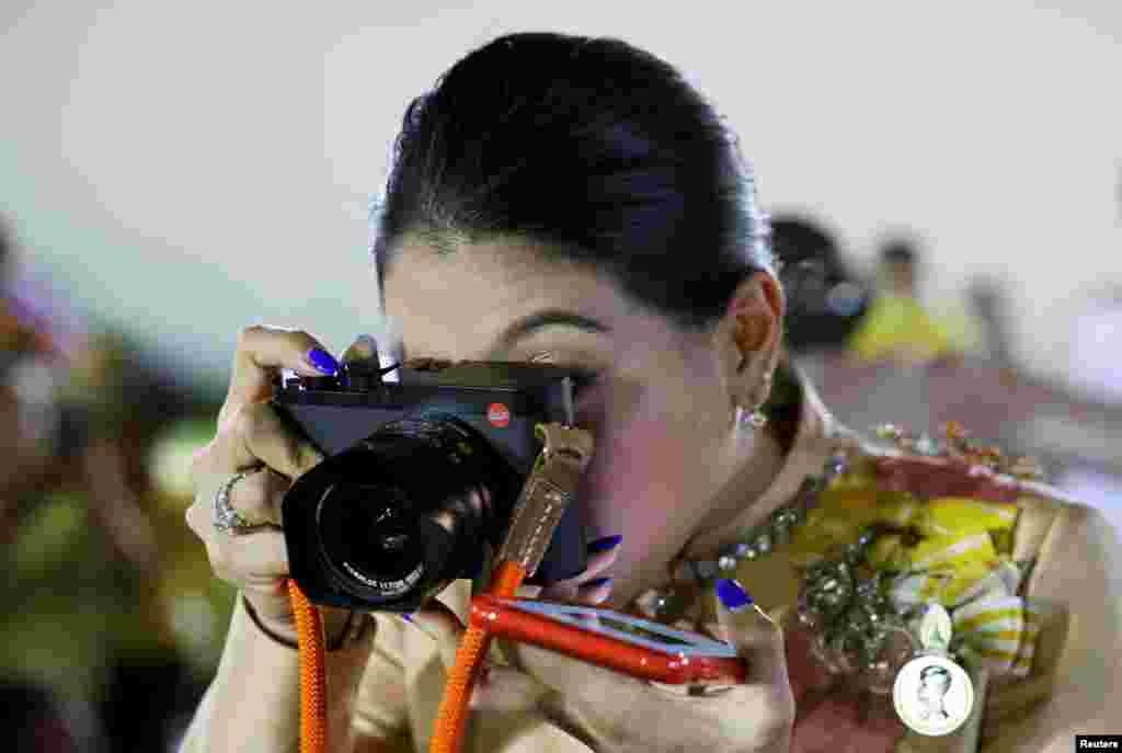 Thailand&#39;s Princess Sirivannavari Nariratana takes pictures after a religious ceremony to commemorate the death of King Chulalongkorn, known as King Rama V, at The Grand Palace in Bangkok, Thailand.