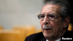 FILE - Guatemala's ex-dictator Efrain Rios Montt sits alone at his table during the 20th day of his trial in the Supreme Court of Justice in Guatemala City, April 18, 2013.