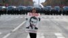 Protesters wearing yellow vests walk on the Champs-Elysees Avenue with the Arc de Triomphe in the background during a national day of protest by the "yellow vests" movement in Paris, Dec. 8, 2018.