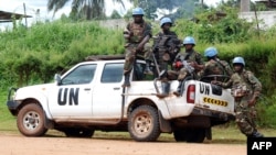 FILE - Blue-helmeted members of the U.N. Organization Stabilization Mission in the Democratic Republic of Congo sit on the back of a pickup truck in Beni, Oct. 23, 2014.