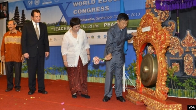 Gubernur Bali Made Mangku Pastika (kanan) memukul gong sebagai tanda dimulainya Kongres Pendidikan Dunia, diamati oleh Dubes RI untuk Argentina Nurmala Kartini Sjahrir (kedua dari kanan). (VOA/Muliarta)