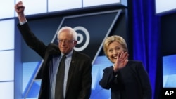 FILE - Democratic presidential candidates, Hillary Clinton and Sen. Bernie Sanders, I-Vt, stand together before the start of the Univision, Washington Post Democratic presidential debate at Miami-Dade College in Florida, March 9, 2016. 
