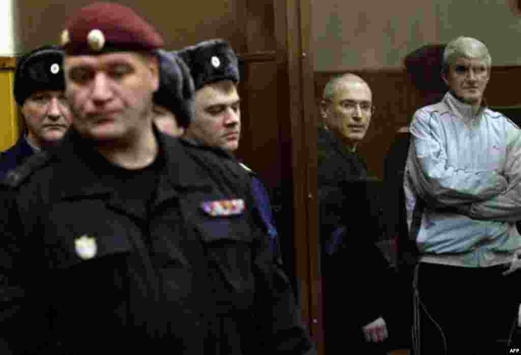 Dec. 28: Mikhail Khodorkovsky and his co-defendant Platon Lebedev, right, are seen at a court room in Moscow. Khodorkovsky's conviction for stealing oil from his own company and laundering the proceeds will likely keep the oil tycoon behind bars for sever