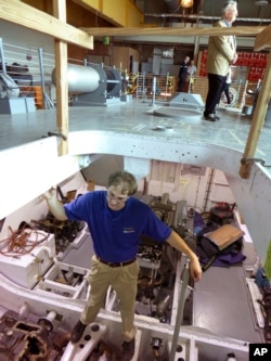 Josh Schick, project historian for the National World War II Museum, stands inside the engine room of PT-305, a World War II patrol torpedo boat being restored at the National World War II Museum in New Orleans, March 8, 2016.