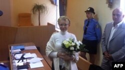 Ukraine's former Prime Minister Yulia Tymoshenko seen inside the court hearing room, with her husband Oleksandr, nearby at right, in Kiev, Ukraine, Wednesday, Aug. 10, 2011. A Ukrainian court on Monday rejected lawyers' requests to free former Prime Minis