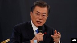 South Korean President Moon Jae-in answers reporters' question during his New Year news conference at the Presidential Blue House in Seoul, South Korea, Jan. 10, 2018.