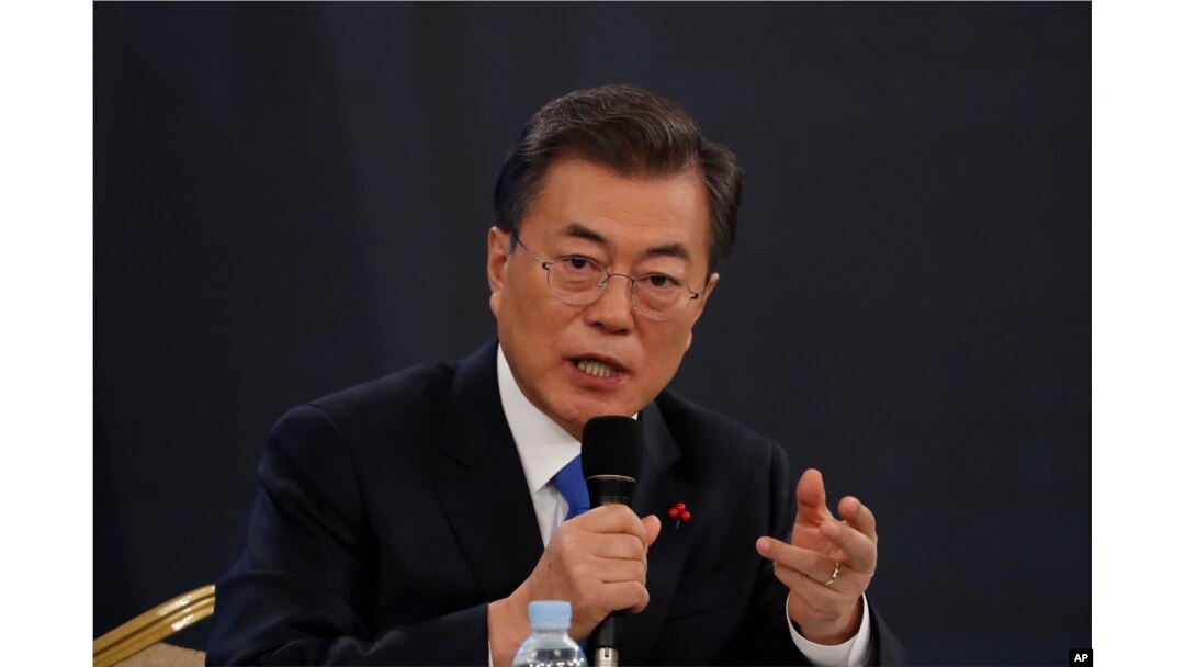 FILE - South Korean President Moon Jae-in answers reporters' question during his New Year news conference at the Presidential Blue House in Seoul, Jan. 10, 2018.