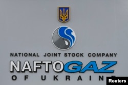 FILE - The logo of the Ukrainian national joint stock company Naftogaz is seen outside the company's headquarters in central Kyiv, March 15, 2016.