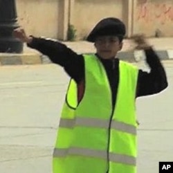 A young Boy Scout directs traffic in Benghazi, March 7, 2011