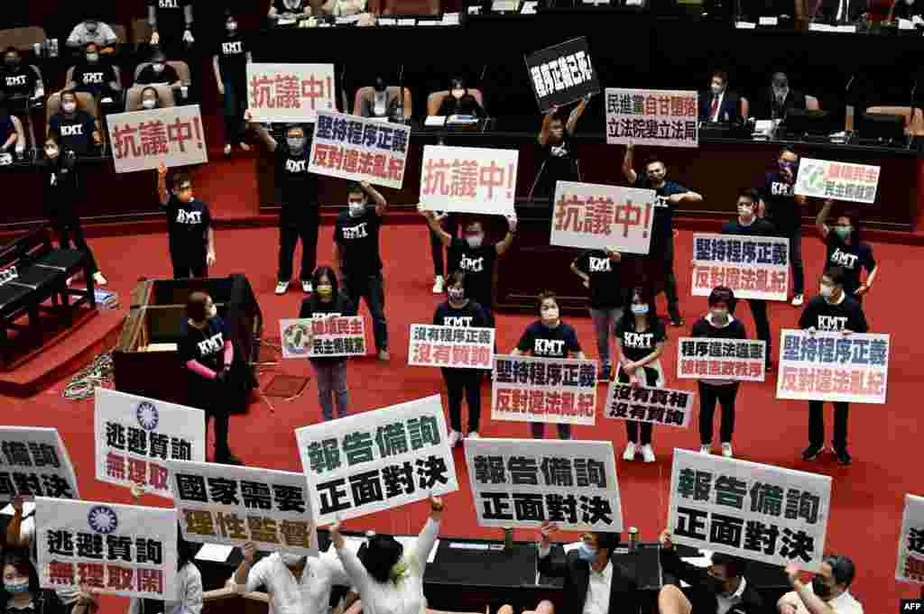 Taiwan&rsquo;s main opposition Kuomintang legislators display placards that read &quot;keep the Procedural Justice&quot; as they protest calling for the government to apologize for coronavirus deaths, at the Parliament in Taipei.