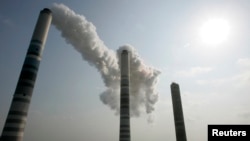 FILE - View of smokestacks, about 200m (656 feet) high, at a thermal power plant in Inchon, west of Seoul, Feb. 1, 2007. 