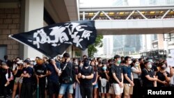 Supporters of jailed activist Edward Leung, gather outside the High Court as Leung appeals against a conviction and sentence, in Hong Kong, China Oct. 9, 2019. Text on flag reads, "Liberate Hong Kong, the revolution of our times."