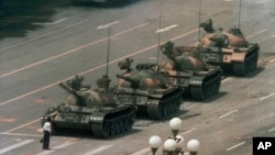 A man stands alone to block a line of tanks heading east on Beijing's Cangan Blvd. in Tiananmen Square, June 5, 1989.