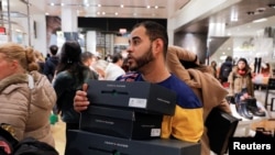 Un trabajador lleva cajas de productos en Macy's Herald Square durante la apertura temprana de las ventas del Black Friday en Manhattan, Nueva York, EE.UU.