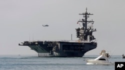 FILE - The USS Carl Vinson sails out of San Diego Harbor, Aug. 22, 2014.