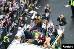 New England Patriots quarterback Tom Brady holds up the Lombardi Trophy as he rides a duck boat on Boston's Boylston Street during the Super Bowl LIII championship parade, Feb 5, 2019.