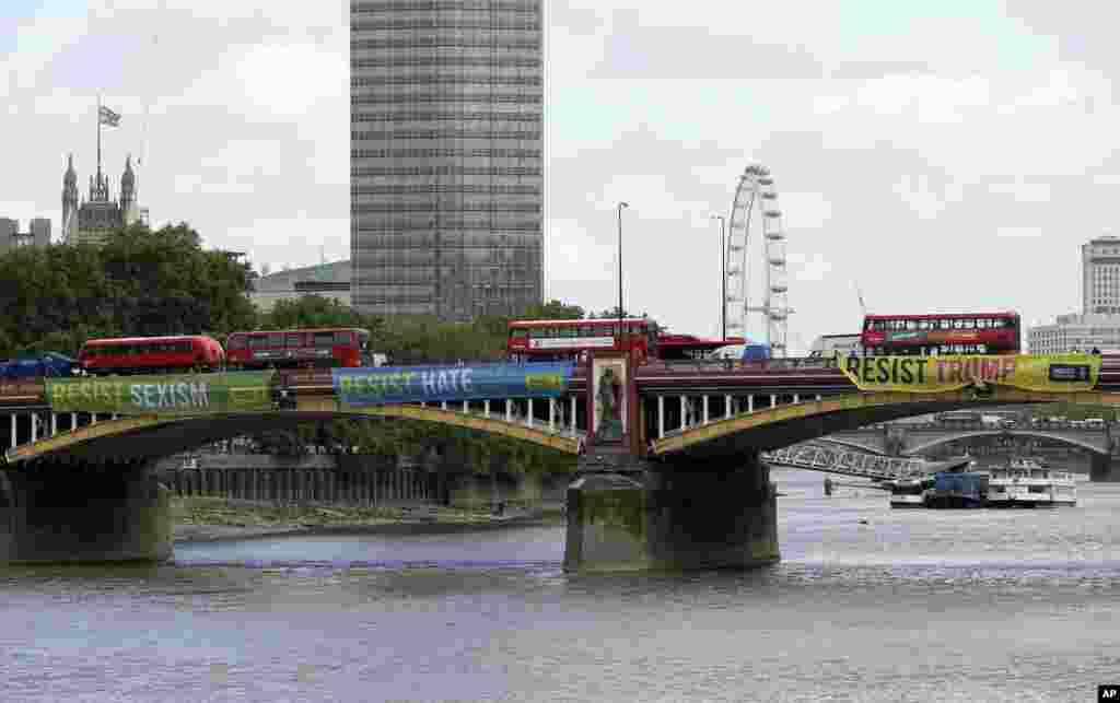 Banners are unfurled by Amnesty International, displayed opposite the U.S. Embassy on Vauxhall Bridge, London, June 3, 2019.