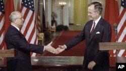 FILE - U.S. President George H.W. Bush (R) and Soviet President Mikhail Gorbachev shake hands following the signing of accords at the White House in Washington, June 1, 1990. Among deals reached was an agreement to reduce their countries' chemical weapons.