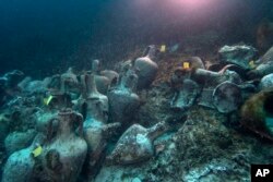 Ancient amphoras lie at the bottom of the sea from a 5th Century B.C. shipwreck, near the coast of Peristera, Greece, April 7, 2019.