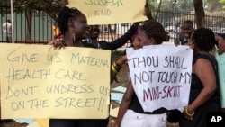 FILE - Women protest against dress code legislation, Feb. 26, 2014, in Kampala, Uganda. This week, the country's goverment introduced a new dress code for civil servants. (AFP PHOTO/Emmanuel NEGA)