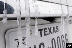 Icicles hang on the back of a vehicle Monday, Feb. 15, 2021, in Houston.