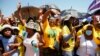 Members of the African National Congress (ANC) react to the arrival of South African President Cyril Ramaphosa during their party’s door-to-door political campaign ahead of the local government elections in Mabopane township north of Pretoria, Oct. 15, 2021.
