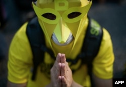 A protester offers prayers on the second day of a demonstration demanding Prime Minister Najib Razak’s resignation and electoral reforms in Kuala Lumpur on August 30, 2015. Tens of thousands of Malaysians swarmed central Kuala Lumpur on August 29.