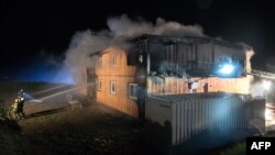 Firemen extinguish fires at a building for asylum seekers in Altenfelden, northern Austria, June 1, 2016. 