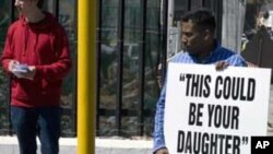 A group of protesters stands outside the South African Parliament on September 21, 2011 in Cape Town, demonstrating against human trafficking.