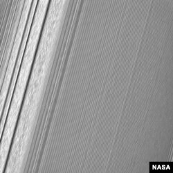This Cassini image features a density wave in Saturn's A ring (at left) that lies around 134,500 km from Saturn. Density waves are accumulations of particles at certain distances from the planet. This feature is filled with clumpy perturbations, which res