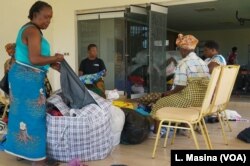 Volunteers sort donated clothes at Abida Mia's house in Blantyre, Malawi.