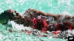 Donata Katai is seen during a swimming practice session in Harare, Zimbabwe, Saturday, July 10, 2021. The southern African nation is sending the black swimmer to the Olympics, the first from her country to the Games.