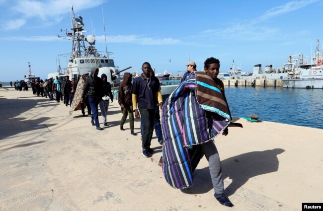 Migrants arrive at a naval base after they were rescued by the Libyan coast guard in Tripoli, Libya, March 13, 2018.
