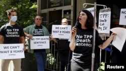 Melinda St. Louis speaks against restriction of access to affordable medicines during a protest outside the hotel where the Trans-Pacific Partnership ministerial meetings are being held in Atlanta, Sept. 30, 2015.