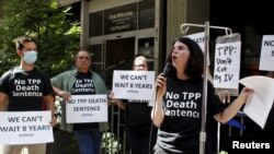 Melinda St. Louis speaks against restriction of access to affordable medicines during a protest outside the hotel where the Trans-Pacific Partnership Ministerial Meetings are being held in Atlanta, Sept. 30, 2015.