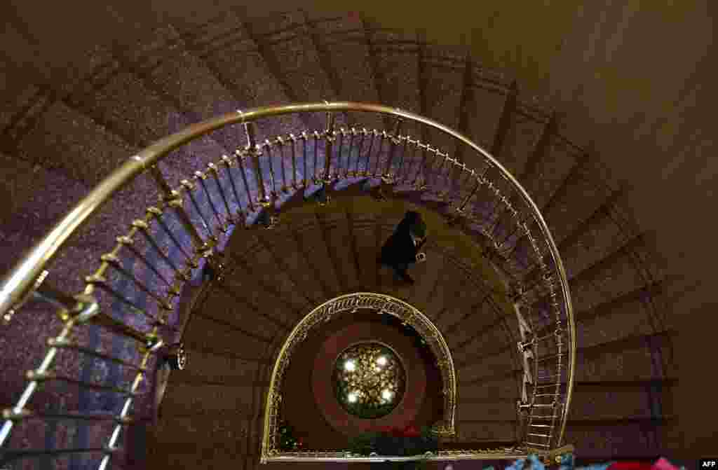 A man walks the stairway inside the Nobel Institute before a news conference in Oslo, Norway. The 2016 Nobel Peace Prize award ceremony will be held Saturday, Dec. 10.