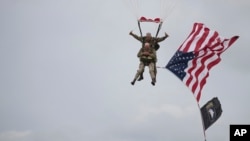 U.S. World War II D-Day veteran Tom Rice, from Coronado, California, parachutes in a tandem jump into a field in Carentan, Normandy, France, June 5, 2019. 