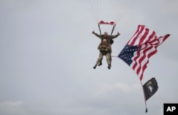 U.S. World War II D-Day veteran Tom Rice, from Coronado, California, parachutes in a tandem jump into a field in Carentan, Normandy, France, June 5, 2019.