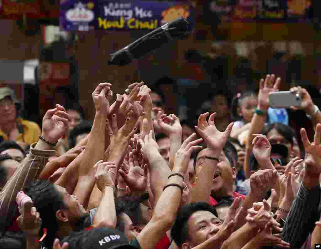 Revelers jostle to catch gift items being thrown to them from a super market in celebration of the Chinese Lunar New Year in Manila, the Philippines.