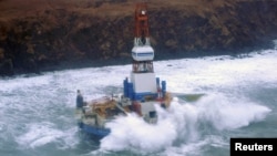 Waves crash over the conical drilling unit Kulluk where it sits aground on the southeast side of Sitkalidak Island, Alaska in this U.S. Coast Guard handout photo taken January 1, 2013.