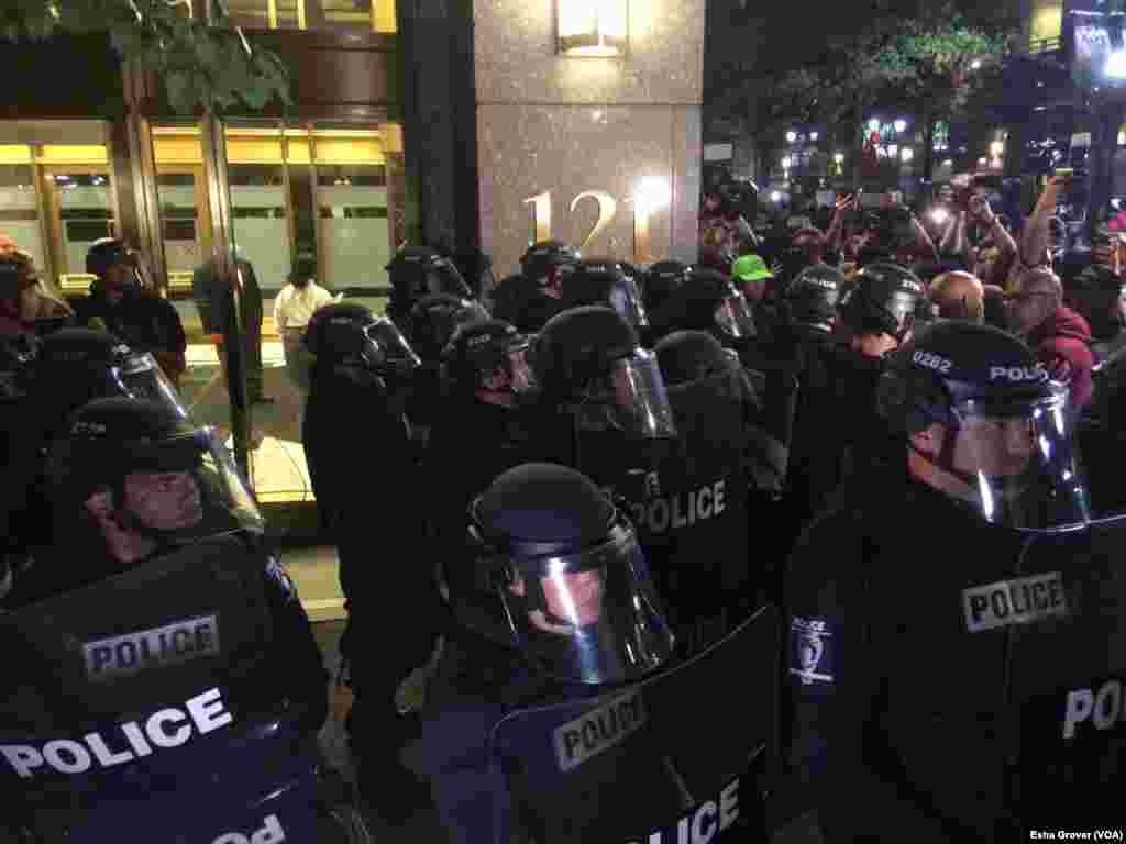 Police stand ready as protesters begin marching in Charlotte, North Carolina, Sept. 22, 2016. The city is seeing the third night of protests following the police shooting death earlier this week of Keith Lamont Scott.