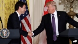 U.S. President Donald Trump shakes hands with Canadian Prime Minister Justin Trudeau during their joint news conference in the East Room of the White House, Feb. 13, 2017, in Washington.
