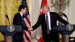 FILE - U.S. President Donald Trump, right, shakes hands with Canadian Prime Minister Justin Trudeau during their joint news conference in the East Room of the White House, Feb. 13, 2017, in Washington.