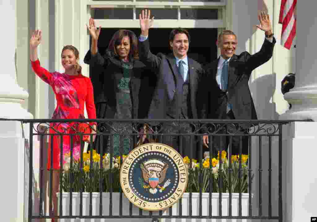 Presiden AS Barack Obama dan ibu negara Michelle Obama bersama PM Kanada Justin Trudeau dan istrinya Sophie Gregoire melambaikan tangan dari atas Balkon Truman dalam upacara penyambutan di Gedung Putih, Washington (10/3). (AP/Andrew Hamik)